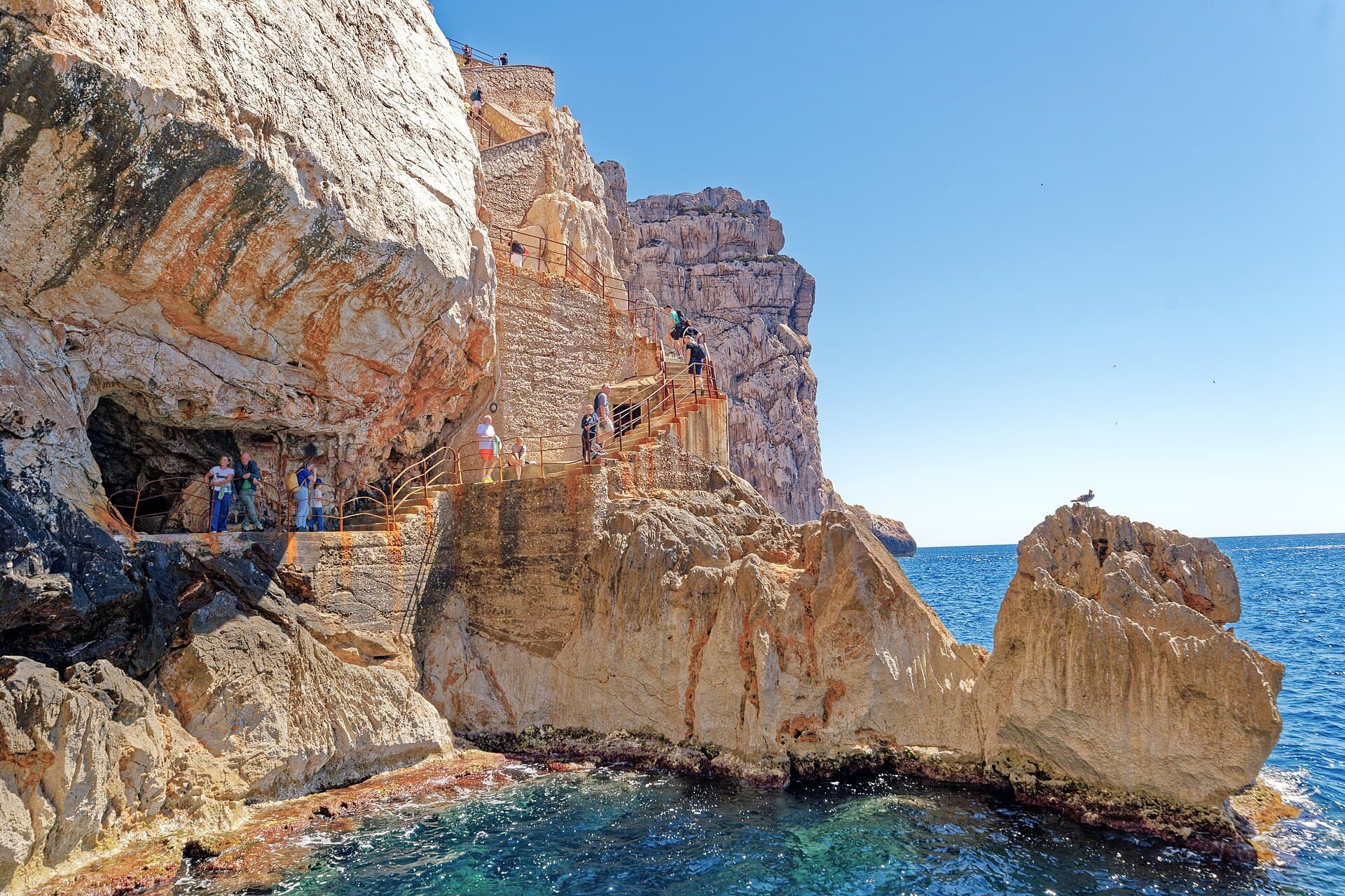 The Escala del Cabirol descends 654 steps along the Capo Caccia cliff to Neptune's Grotto: booking is mandatory for the walk down.