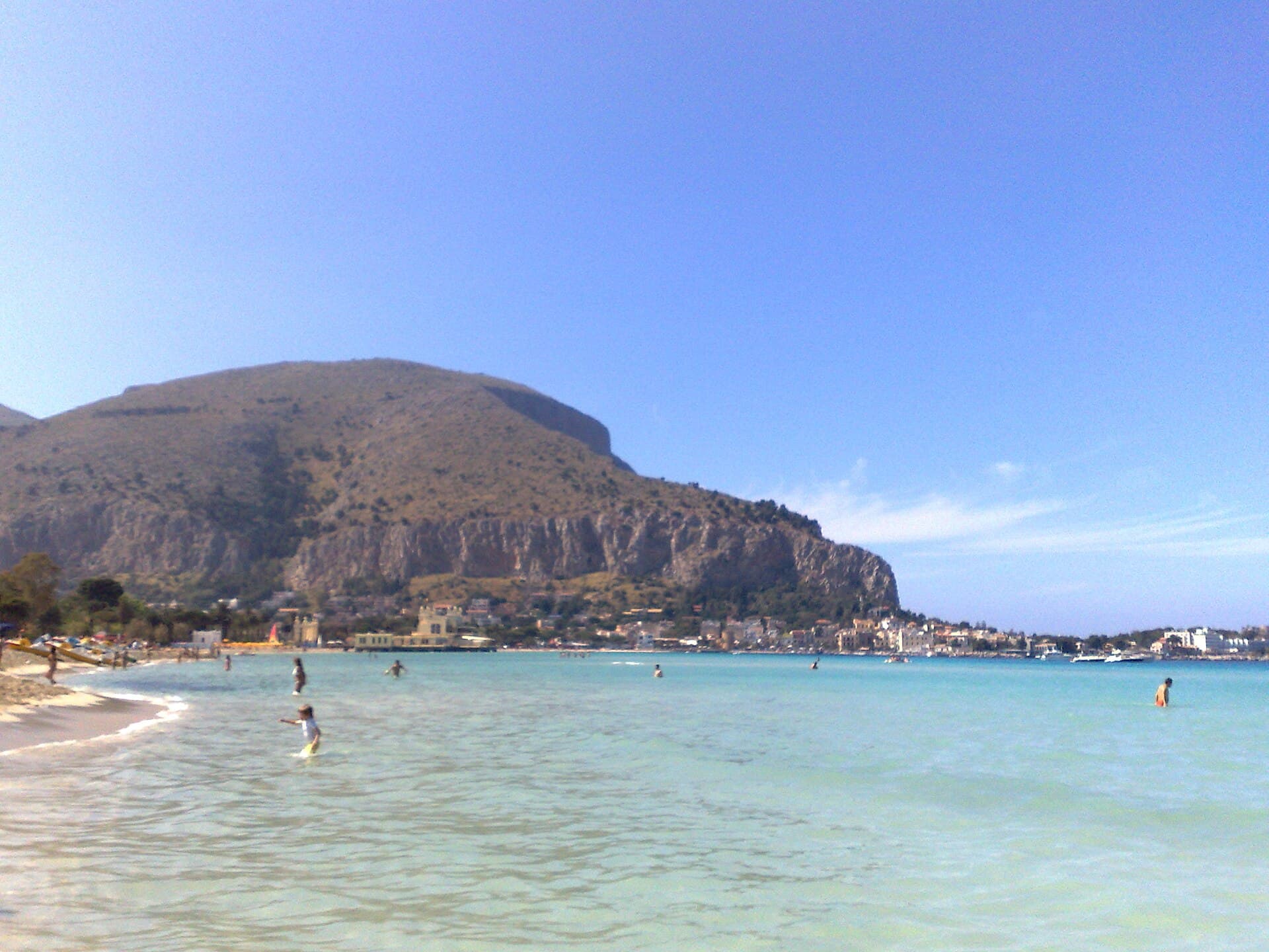 Mondello beach under Monte Pellegrino: the Palermitans' turquoise crescent, half an hour by bus from the centre.